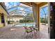 Relaxing screened-in lanai featuring a pool, dining table, and comfortable seating for outdoor enjoyment at 8308 Mobile Cir, Weeki Wachee, FL 34613