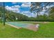 A photograph of shuffleboard courts surrounded by manicured lawns and mature shade trees at 8308 Mobile Cir, Weeki Wachee, FL 34613