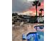Relaxing backyard with sunset views, features a private pool with a large lounging area at 8722 Thornwood Ln, Tampa, FL 33615
