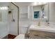 Bathroom features tiled shower, modern vanity, and ample lighting at 8722 Thornwood Ln, Tampa, FL 33615