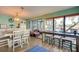 Bright dining room with access to lanai, modern lighting, and a table with bar seating for entertaining at 8722 Thornwood Ln, Tampa, FL 33615