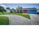 Charming single-story home featuring a well-maintained front yard and a colorful red front door at 8722 Thornwood Ln, Tampa, FL 33615