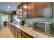Kitchen with wood cabinets, granite countertops, stainless steel appliances at 8722 Thornwood Ln, Tampa, FL 33615
