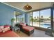 Screened lanai with outdoor seating, tiled floor, overlooking a pool and waterfront at 8722 Thornwood Ln, Tampa, FL 33615