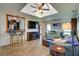 Open concept living room with tiled floor, skylight and bar seating into kitchen at 8722 Thornwood Ln, Tampa, FL 33615