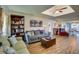 Open living room featuring hardwood floors, comfortable seating, and access to a dining area at 8722 Thornwood Ln, Tampa, FL 33615