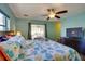 Bedroom with ceiling fan, flatscreen TV, and access to lanai at 8722 Thornwood Ln, Tampa, FL 33615