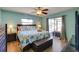 Relaxing main bedroom boasts a ceiling fan, backyard views and ensuite bathroom access at 8722 Thornwood Ln, Tampa, FL 33615