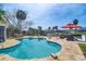A luxurious backyard pool with outdoor lounge seating and access to waterfront canal at 8722 Thornwood Ln, Tampa, FL 33615