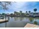 Scenic waterfront view showcasing calm water, neighboring houses, mature trees, and private boat docks at 8722 Thornwood Ln, Tampa, FL 33615