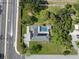 An aerial view showcases a property with solar panels, a screened-in pool, and a convenient location at 903 Tomahawk Trl, Brandon, FL 33511