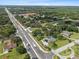 Aerial view of the home situated near a large commercial district and a park, with mature trees and green lawns at 903 Tomahawk Trl, Brandon, FL 33511