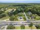 Aerial view of the neighborhood with a home near a highway and surrounded by mature trees and green lawns at 903 Tomahawk Trl, Brandon, FL 33511