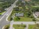 An aerial view showcases this home's large lot, mature trees, pool enclosure, and convenient location at 903 Tomahawk Trl, Brandon, FL 33511