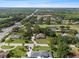A high aerial view of a home near a commercial district with many mature trees and green lawns in the area at 903 Tomahawk Trl, Brandon, FL 33511