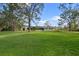 Lush backyard with mature trees overlooking the back of the home at 903 Tomahawk Trl, Brandon, FL 33511