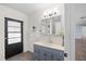 Bathroom featuring a sleek vanity with chrome faucet and a door leading outside at 903 Tomahawk Trl, Brandon, FL 33511