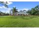 Spacious front yard with a well-maintained lawn and a charming single-story home at 903 Tomahawk Trl, Brandon, FL 33511