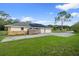 Side view of a home showcasing the garage and the solar panels on the roof at 903 Tomahawk Trl, Brandon, FL 33511