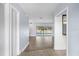 Bright hallway with tile floors leading to sliding glass doors with pool view at 903 Tomahawk Trl, Brandon, FL 33511