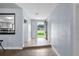 Inviting hallway with tile flooring, featuring access to the kitchen and front door at 903 Tomahawk Trl, Brandon, FL 33511
