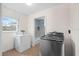Convenient laundry room with washer, dryer and natural light from window at 903 Tomahawk Trl, Brandon, FL 33511