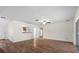 Spacious living room with wood laminate flooring, ceiling fan, and plenty of natural light at 903 Tomahawk Trl, Brandon, FL 33511