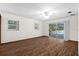 Open living room with sliding glass doors and laminate wood flooring at 903 Tomahawk Trl, Brandon, FL 33511
