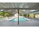 Covered pool area with screen enclosure and mature landscaping provides a tropical retreat at 903 Tomahawk Trl, Brandon, FL 33511