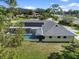 A view of the home's rear exterior with solar panels and a screened-in pool area at 903 Tomahawk Trl, Brandon, FL 33511