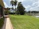 Expansive backyard with lush lawn and serene lake view, perfect for outdoor activities at 919 Ballinger Rd, Lutz, FL 33548