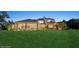 Expansive backyard featuring a well-manicured lawn, covered patio, and outdoor gazebo with lush landscaping at 919 Ballinger Rd, Lutz, FL 33548