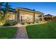 Inviting covered patio with brick pillars, outdoor seating, and a well-manicured lawn at 919 Ballinger Rd, Lutz, FL 33548
