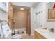 Tiled bathroom featuring a shower with a curtain, vanity with sink, toilet, and wood cabinets at 919 Ballinger Rd, Lutz, FL 33548