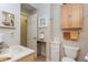Well-lit bathroom showcasing a sink, toilet, cabinet, and nautical-themed decorations on the walls at 919 Ballinger Rd, Lutz, FL 33548