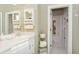 Bright bathroom with ample counter space and a view through the doorway to the rest of the house at 919 Ballinger Rd, Lutz, FL 33548