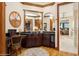 Vanity with wood cabinets, black countertop, and views to bedroom at 919 Ballinger Rd, Lutz, FL 33548