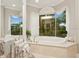 Bright bathroom featuring a large tub with jets and a window with outdoor views at 919 Ballinger Rd, Lutz, FL 33548