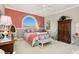 Charming bedroom featuring a large arched window and stylish decor with neutral color scheme at 919 Ballinger Rd, Lutz, FL 33548
