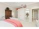 Bedroom with a decorative cabinet, large windows, and carpet flooring at 919 Ballinger Rd, Lutz, FL 33548