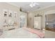 Bright bedroom with artwork, vanity, and access to bathroom and hallway with upstairs access at 919 Ballinger Rd, Lutz, FL 33548