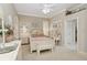 Bedroom with a charming vanity and bench, complemented by a large window, offering a cozy retreat at 919 Ballinger Rd, Lutz, FL 33548