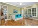 Cozy bedroom with hardwood floors, featuring a daybed with blue pillows and a scenic window view at 919 Ballinger Rd, Lutz, FL 33548