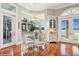 Bright breakfast nook with lake views, featuring hardwood floors, and adjacent patio access at 919 Ballinger Rd, Lutz, FL 33548