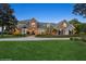 Stately brick home featuring professional landscaping, a circular driveway, and decorative windows at 919 Ballinger Rd, Lutz, FL 33548