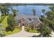 Stunning waterfront brick home featuring mature landscaping and beautiful lake views at 919 Ballinger Rd, Lutz, FL 33548