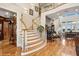 Grand two-story foyer featuring a sweeping staircase, hardwood floors, and abundant natural light at 919 Ballinger Rd, Lutz, FL 33548