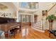 Grand foyer with a curved staircase, gleaming hardwood floors, and elegant accents, showcasing luxurious living at 919 Ballinger Rd, Lutz, FL 33548