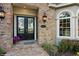 Inviting front entrance with double doors, brick accents, and a charming address plaque at 919 Ballinger Rd, Lutz, FL 33548