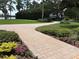 Paver walkway leading to lush lawns and gardens, creating a welcoming entrance and curb appeal at 919 Ballinger Rd, Lutz, FL 33548